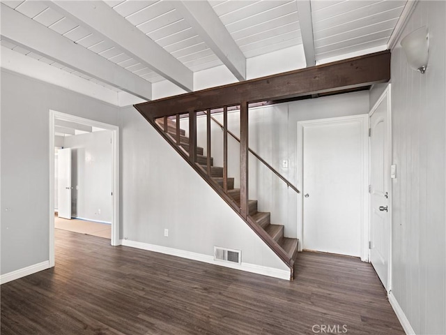 staircase featuring beamed ceiling, hardwood / wood-style floors, and wood ceiling