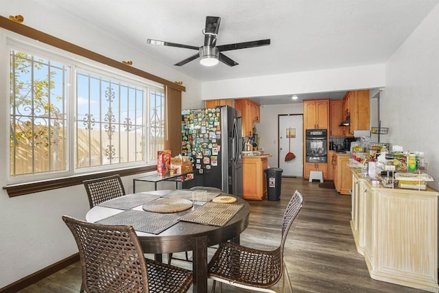 dining area featuring ceiling fan and dark hardwood / wood-style flooring