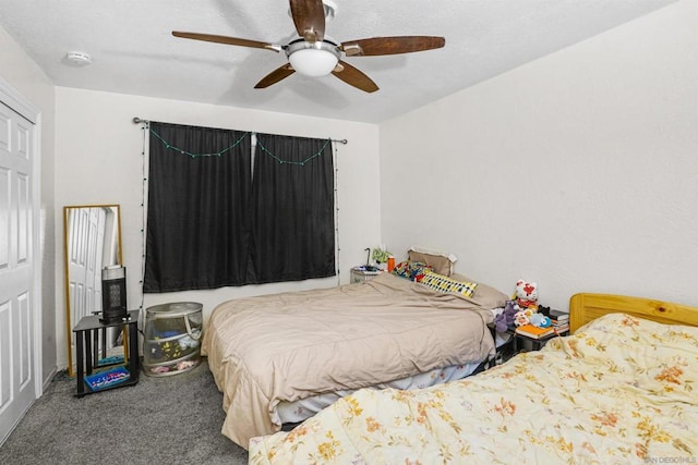 bedroom featuring ceiling fan and carpet