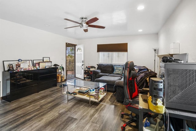 living room with dark wood-type flooring and ceiling fan