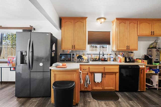 kitchen with dark hardwood / wood-style flooring, sink, and black appliances