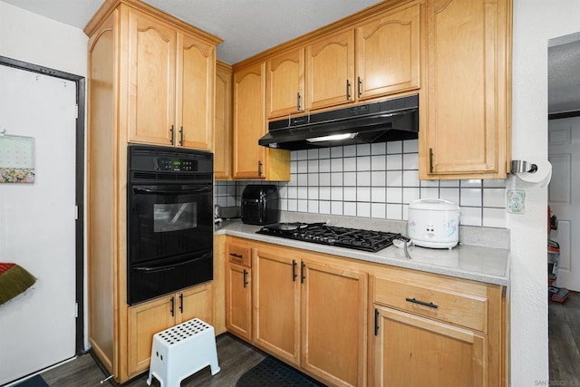 kitchen with tasteful backsplash, light brown cabinetry, and black appliances