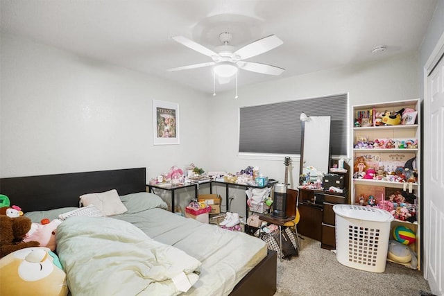 carpeted bedroom with ceiling fan and a closet