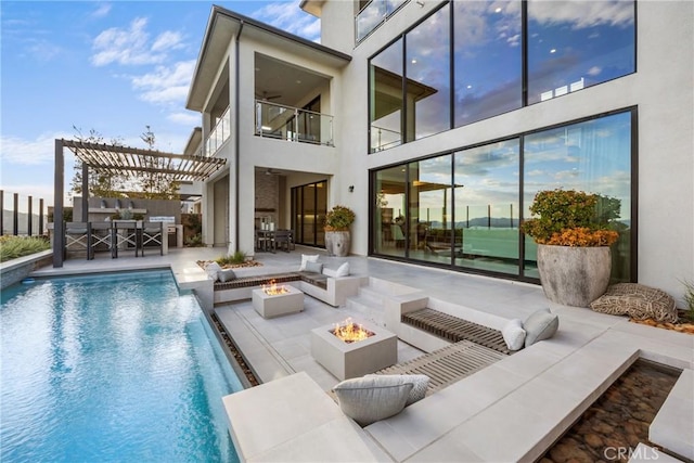 back of property featuring a pergola, an outdoor living space with a fire pit, and a patio