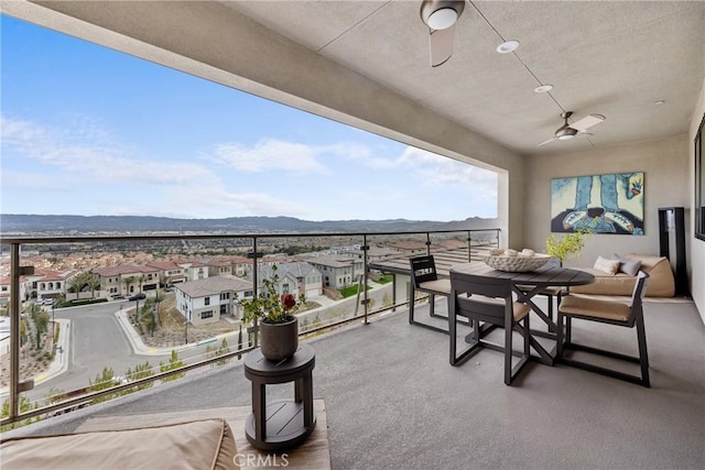 balcony featuring a mountain view and ceiling fan