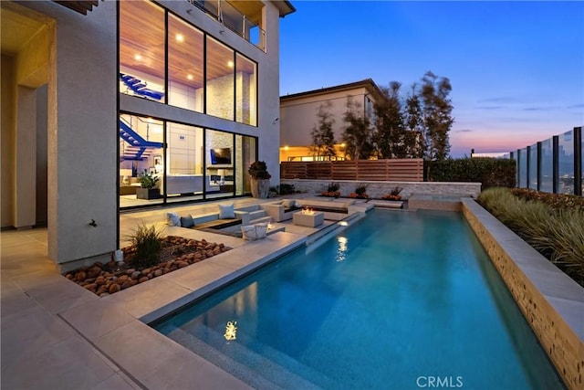 view of pool at dusk