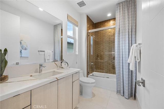 full bathroom with vanity, tiled shower / bath combo, tile patterned floors, and toilet