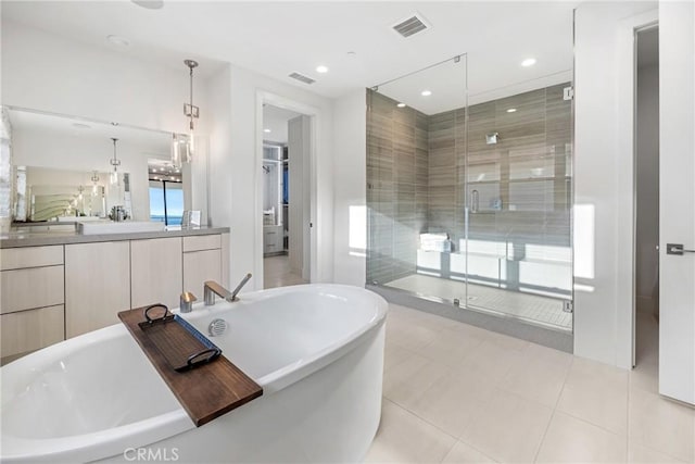 bathroom with vanity, tile patterned floors, and plus walk in shower