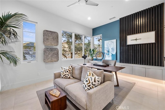 living room with ceiling fan and light tile patterned floors