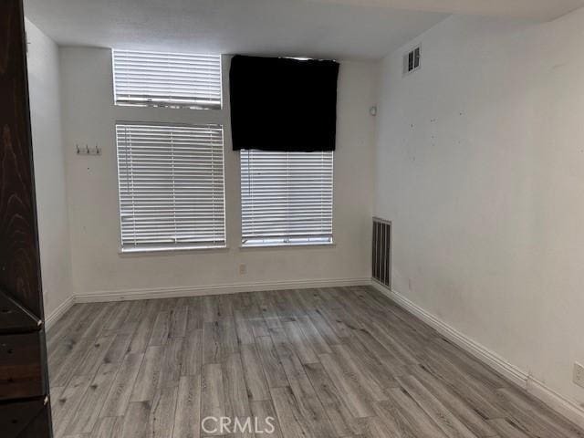 spare room with light hardwood / wood-style flooring