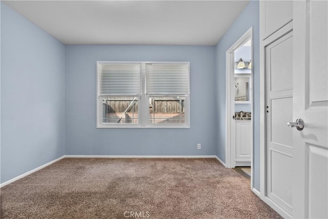 unfurnished room featuring carpet