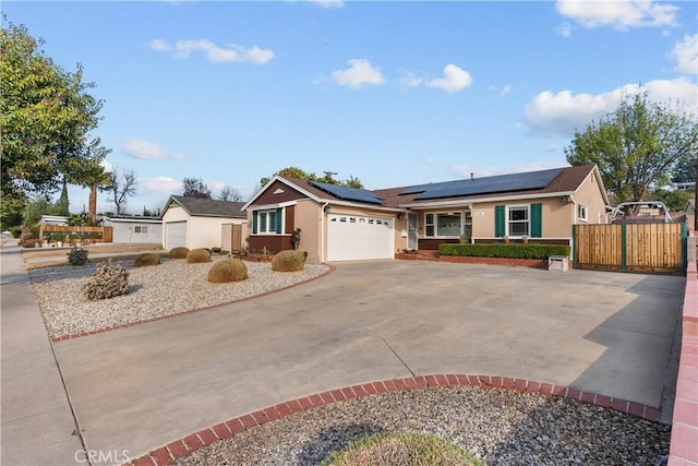 single story home with a garage and solar panels