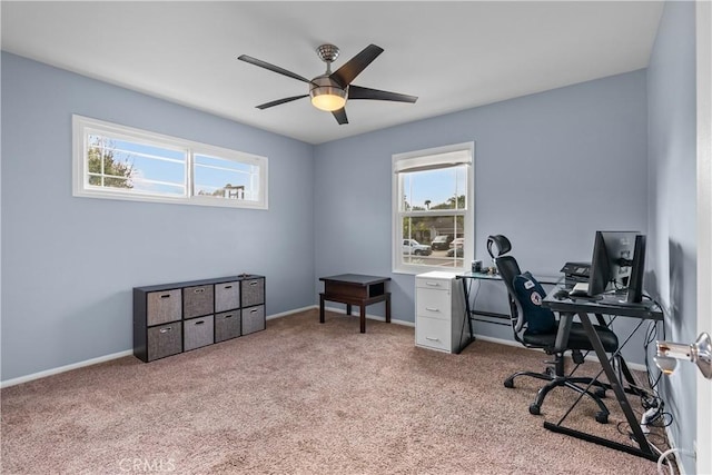 carpeted home office with plenty of natural light and ceiling fan