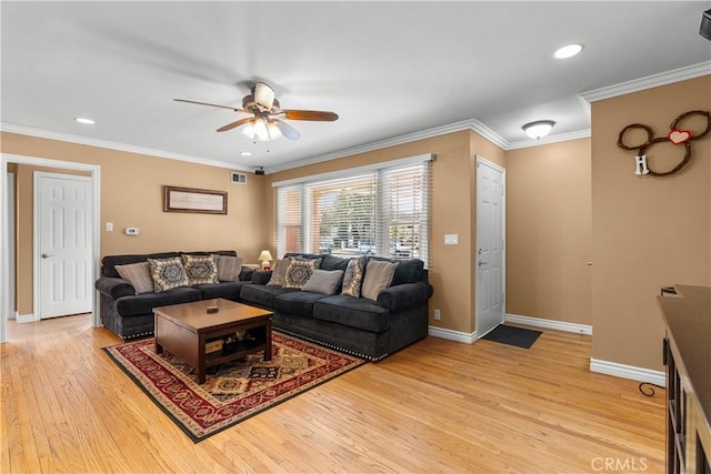 living room with crown molding, light hardwood / wood-style flooring, and ceiling fan