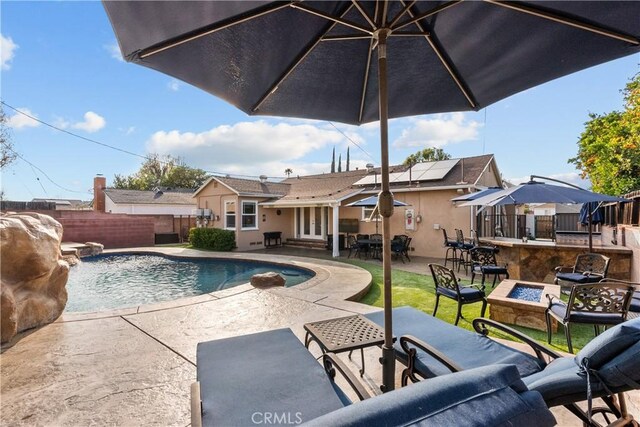 view of pool with a patio area and an outdoor fire pit