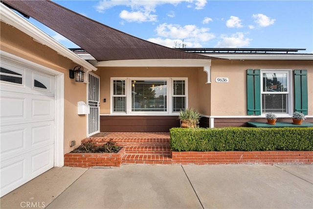 doorway to property with a garage