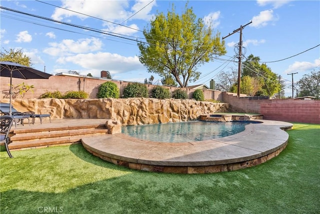 view of swimming pool with an in ground hot tub and a yard