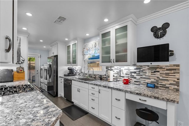 kitchen with white cabinetry, sink, stainless steel appliances, and light stone countertops