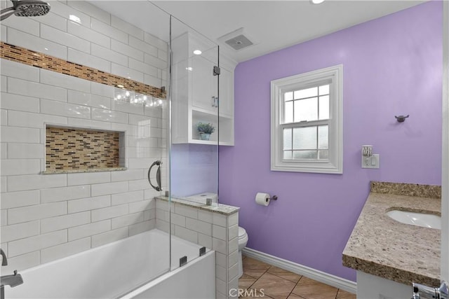 full bathroom featuring vanity, shower / bath combination with glass door, and toilet