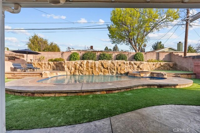 exterior space with a pool with hot tub and a patio area