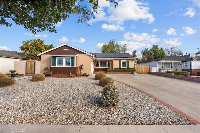 single story home featuring solar panels