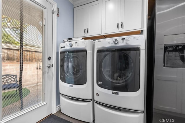 washroom featuring washer and clothes dryer and cabinets