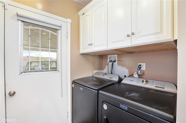 laundry area featuring cabinets and washing machine and dryer