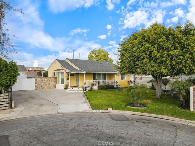 single story home with a front yard and covered porch