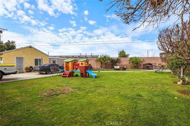 view of yard with a patio and a playground