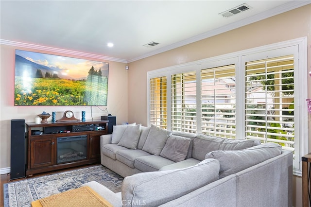 living room featuring crown molding, plenty of natural light, and light hardwood / wood-style floors