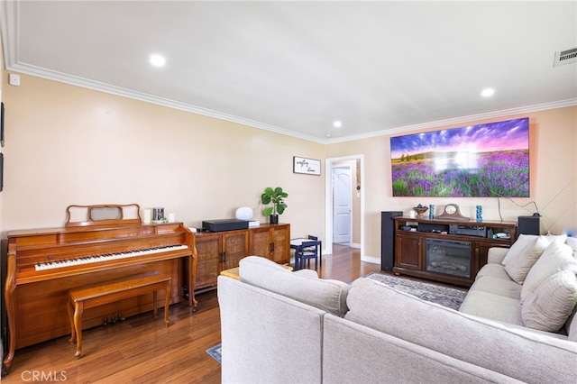 living room with hardwood / wood-style floors and ornamental molding