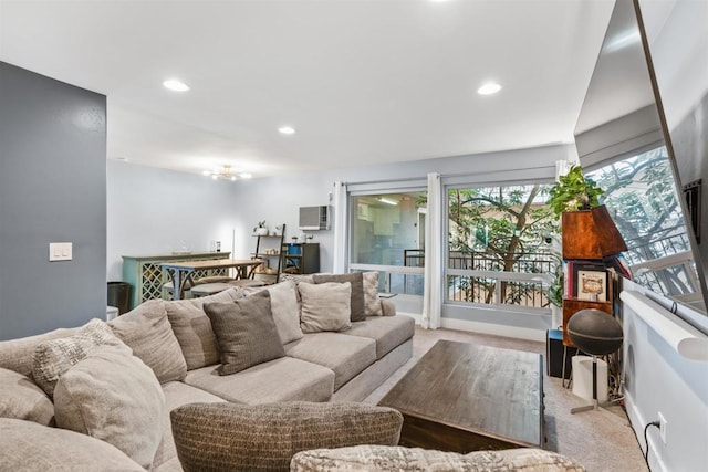 living room featuring light colored carpet and an AC wall unit