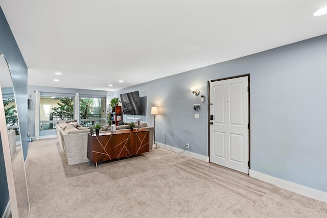 living room with light carpet, baseboards, and recessed lighting