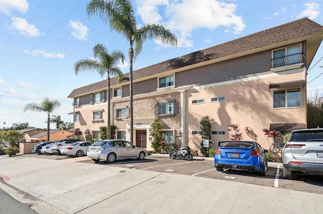 view of property featuring uncovered parking