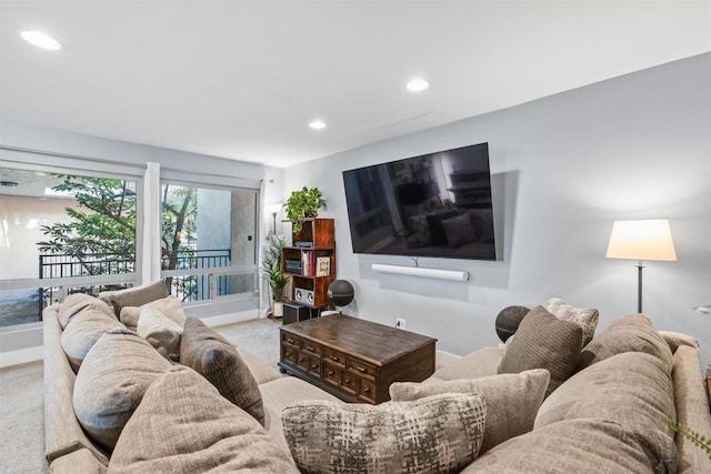 living room featuring carpet floors, baseboards, and recessed lighting