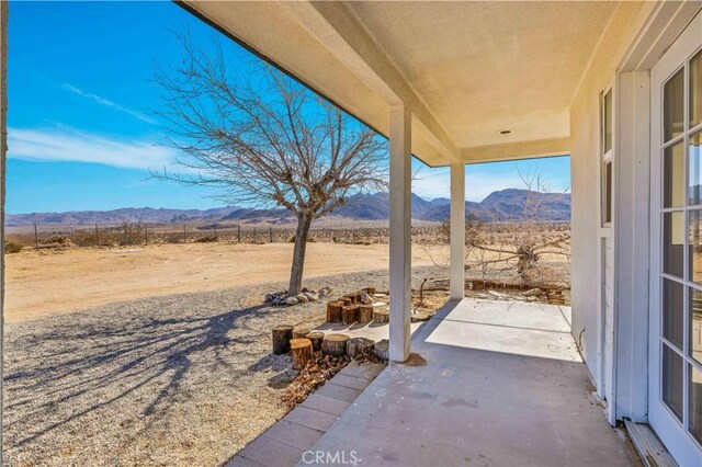 view of patio / terrace with a mountain view