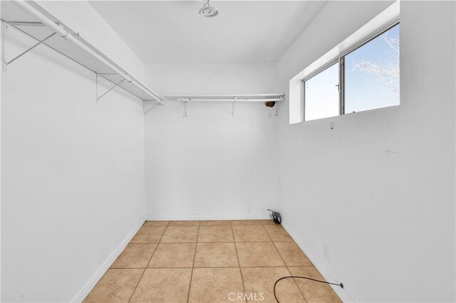 walk in closet featuring light tile patterned floors