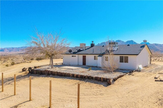 rear view of house with a mountain view