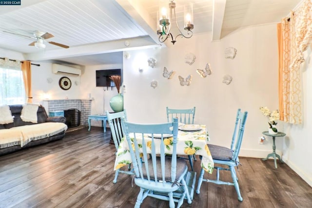 dining space featuring dark hardwood / wood-style floors, ceiling fan with notable chandelier, beamed ceiling, a brick fireplace, and a wall unit AC