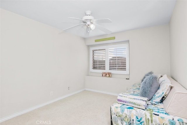 sitting room featuring ceiling fan and light colored carpet