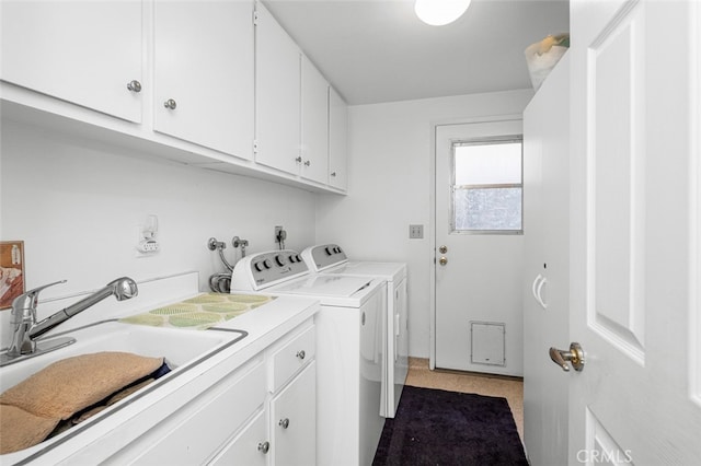 laundry room featuring cabinets, separate washer and dryer, and sink