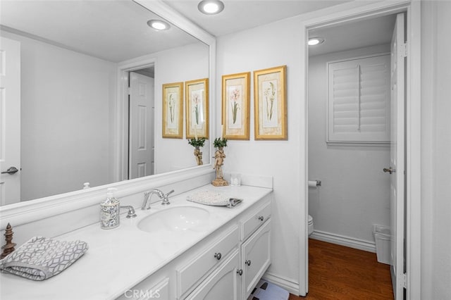 bathroom with vanity, hardwood / wood-style floors, and toilet