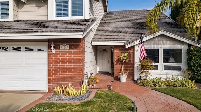 view of exterior entry with a garage