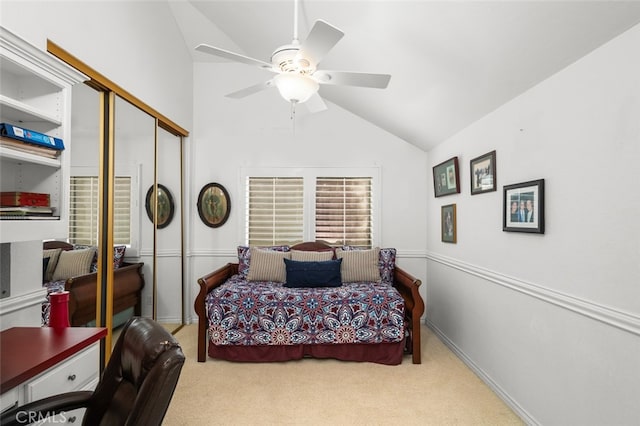 bedroom featuring vaulted ceiling, light carpet, ceiling fan, and a closet