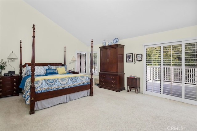 carpeted bedroom with lofted ceiling and access to exterior