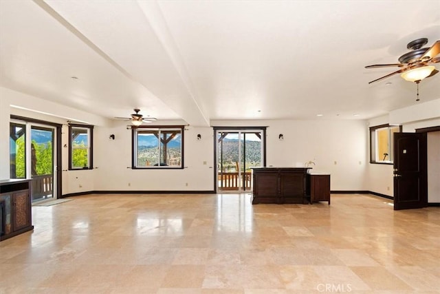 unfurnished living room with ceiling fan