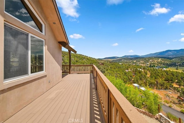 wooden deck featuring a mountain view