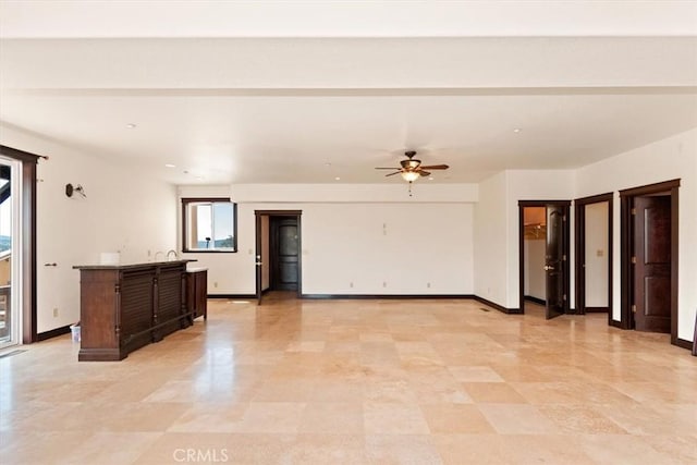 unfurnished living room with ceiling fan