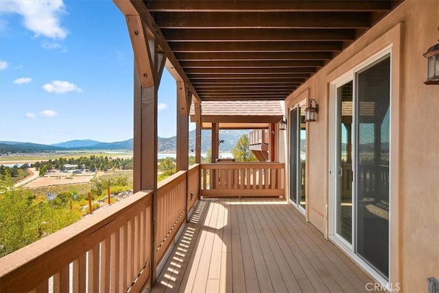 wooden deck featuring a mountain view