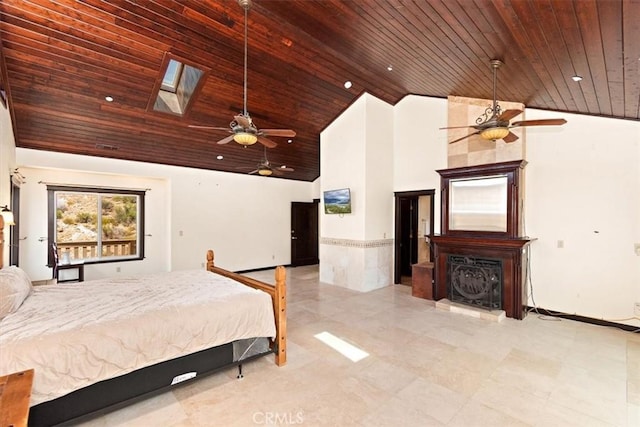 bedroom with wood ceiling, a skylight, and high vaulted ceiling